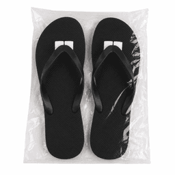 Black rubber thongs displayed on a clear bag, featuring a simple design and a logo on the straps.