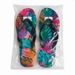 Full colour rubber thongs featuring a vibrant tropical leaf design with black straps, packaged in a clear bag.
