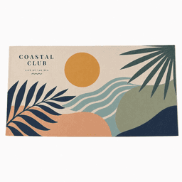 A sandless beach towel featuring a colourful coastal design with sun, waves, and palm leaves. It has a logo.