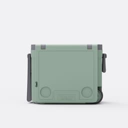 A green cooler box with a table and chair attached, featuring a handle and wheels for easy transport.