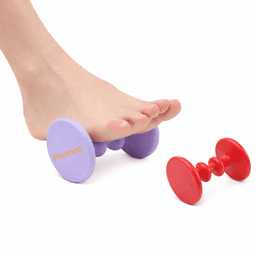 A foot massager in purple and red, shaped like dumbbells, with a foot resting on the purple part.