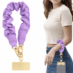 A purple scrunchie keychain with gold hardware, attached to a model's wrist.
