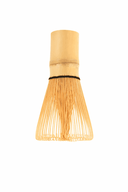 A bamboo tea whisk with thin, flexible bristles and a smooth handle, crafted in natural bamboo colour.