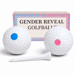 A set of two white golf balls, one with a blue dot and one with a pink dot, alongside a white tee and a decorative box.