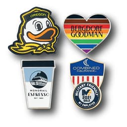 A collection of four lapel pins featuring a duck, a rainbow heart, a coffee cup, and a shield with branding.
