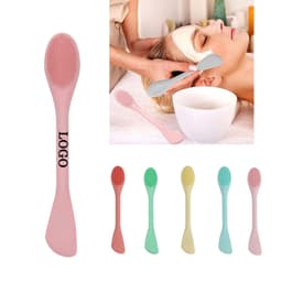 A double-ended silicone face mask brush featuring various pastel colours, including pink, green, and yellow.
