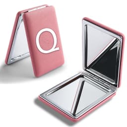 A pink portable mirror with a textured exterior and a logo, featuring two reflective surfaces inside.