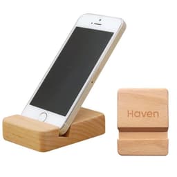 A wooden phone stand with a light finish holding a smartphone, accompanied by a small wooden block with a logo.