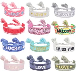 A collection of embroidered bracelets with tassels featuring various colours and messages, including pink, white, and blue.