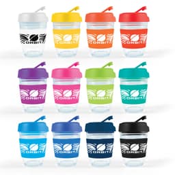 A set of reusable coffee cups in various colors with flip lids and branding. Each cup features a transparent body and a colored lid.