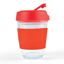 A reusable coffee cup with a clear body and a bright red flip lid, featuring a matching silicone sleeve for grip.