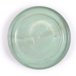 A round, translucent green flyer with a smooth surface and a subtle marbled effect. Features a logo on the bottom.