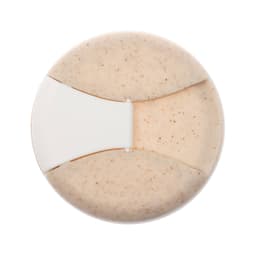 A reusable coffee cup featuring a natural cork band and a light tan-colored body with speckles. It has a logo.