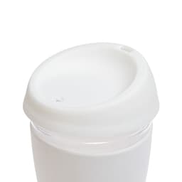 A reusable coffee cup featuring a clear body and a white silicone lid.