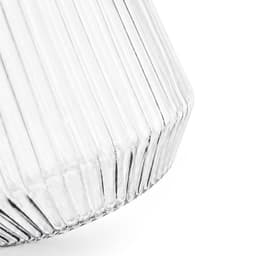 A clear glass tumbler with a ribbed design, featuring a tapered shape and a smooth finish.