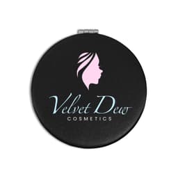 A round black compact mirror featuring a logo with a profile silhouette and "Velvet Dew Cosmetics" text.