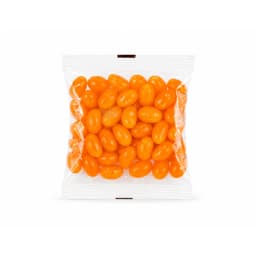 A clear cello bag filled with bright orange jelly beans.