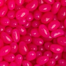 A close-up of glossy pink jelly beans arranged closely together, showcasing their vibrant colour and smooth texture.