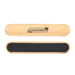 A bamboo nail file with a smooth surface and a dark grit side, featuring a branding logo.