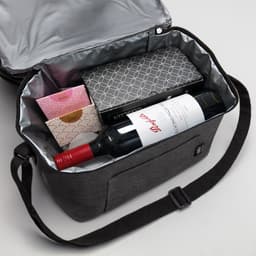 A drink bottle bag in grey containing a bottle of red wine and two other boxed items, with a silver interior.