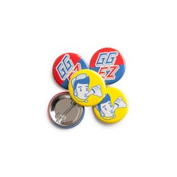 A set of colourful 32mm round badges featuring yellow, red, and blue designs with illustrations and a logo.