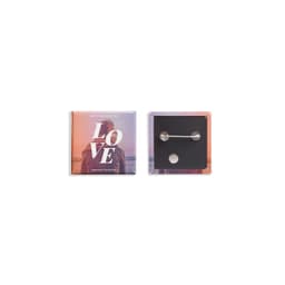 A square badge featuring a colourful design and a pin backing, ideal for custom printing.