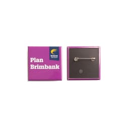 A square badge featuring a purple exterior with a pin back, showcasing a logo on one side.