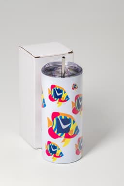A drink tumbler with a colourful fish design, featuring a clear lid and straw, packaged in a white box.