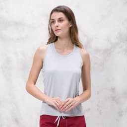 A light grey singlet with a relaxed fit, featuring a logo on the side and worn by a model.