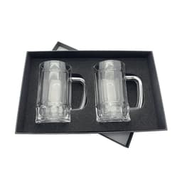 A set of two clear glass beer mugs, presented in a black gift box with a velvet interior.