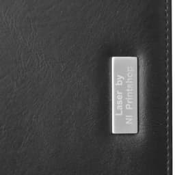 A black portfolio with a metallic label on the front, featuring a logo and smooth texture.