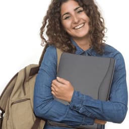 A woman with curly hair is smiling while holding a grey leather compendium. She wears a denim shirt and has a backpack.
