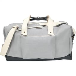 A grey cotton duffel bag with contrasting dark base, featuring two handles and a shoulder strap. It has a front pocket and a logo.