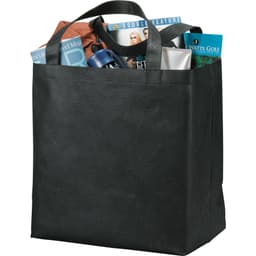A black non-woven tote bag filled with various items including magazines, a drink bottle, and personal care products.