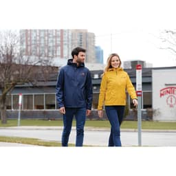 A navy and yellow rain jacket on two people walking outside, featuring a branding logo on the jackets.
