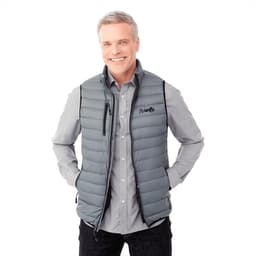 A grey men's down vest with a logo, featuring a zippered front and pockets, worn over a checked shirt.