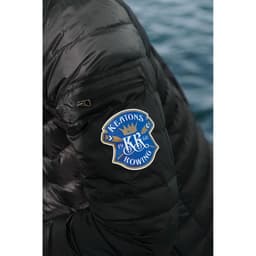 A black puffer jacket featuring a logo on the sleeve, showcasing its light down design.