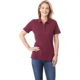 A burgundy women's polo shirt with short sleeves and a logo on the sleeve.