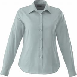 A women's button-up shirt in a soft green colour, featuring long sleeves and a classic collar. It has a logo on it.