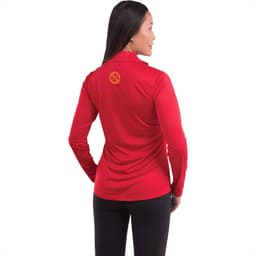 A woman wearing a red long-sleeve half zip jacket, featuring a logo on the back.