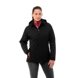 A woman poses in a black insulated softshell jacket with a pink interior, featuring a logo on the sleeve.