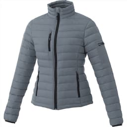 A grey puffer jacket featuring a zip front, stand collar, and multiple zippered pockets. Includes a logo on the sleeve.