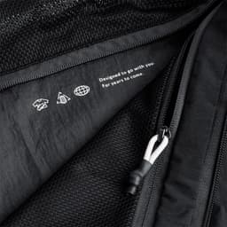 A black packing cube with a mesh panel and zip closure, featuring a subtle logo and design details.