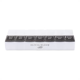 A clear pill case with eight compartments labelled for days of the week, featuring black lids and a logo.