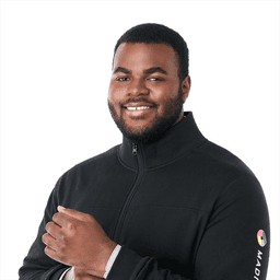 A man wearing a black eco fleece full zip jacket, smiling, with a logo on the sleeve.