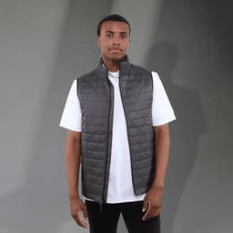 A lightweight packable insulated puffer vest in dark grey, featuring a high collar and a fitted design.
