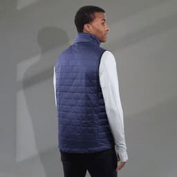A navy insulated puffer vest with a high collar and lightweight design, worn by a model from the back.