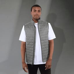 A lightweight, packable insulated puffer vest in grey, featuring a zip closure and a simple design.
