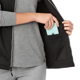 A black women's softshell vest with a zippered pocket, featuring a grey long-sleeve shirt underneath.