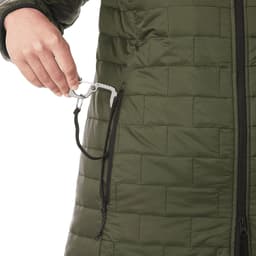 A green women's lightweight packable insulated puffer jacket with a hand reaching into a zippered pocket.